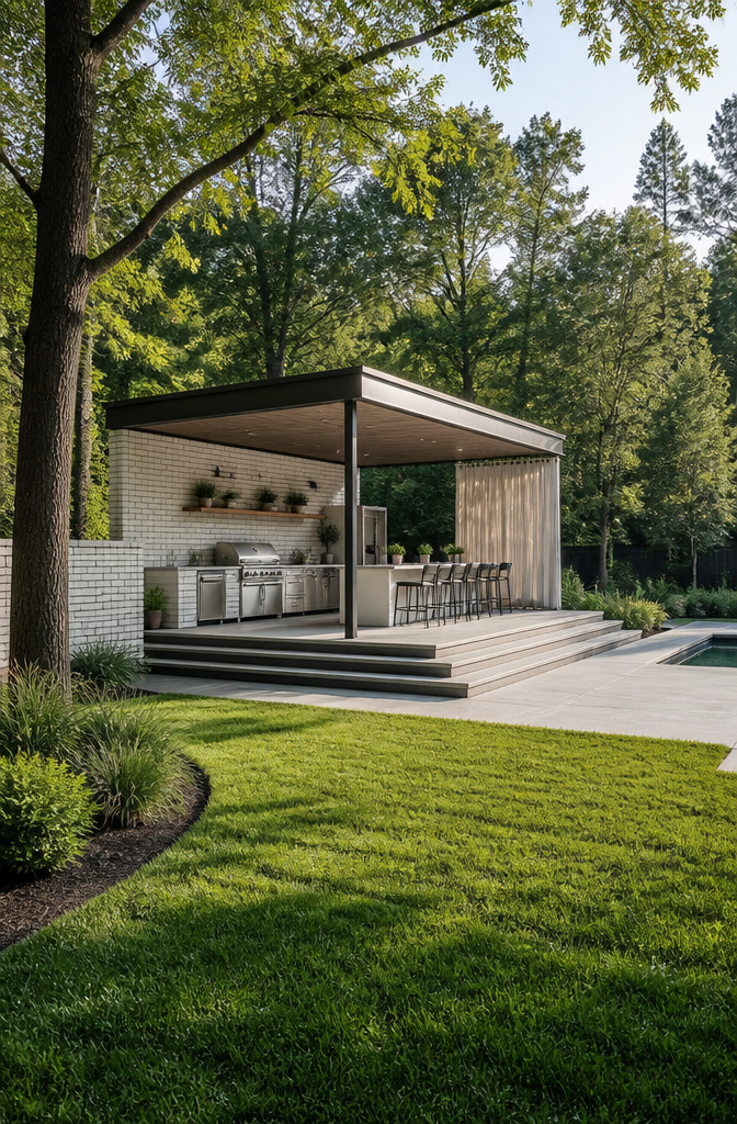 An open-air outdoor kitchen with stainless appliances and no overhead cover.